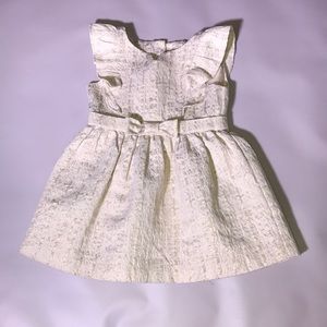 Oshkosh cream with gold metallic threading detail